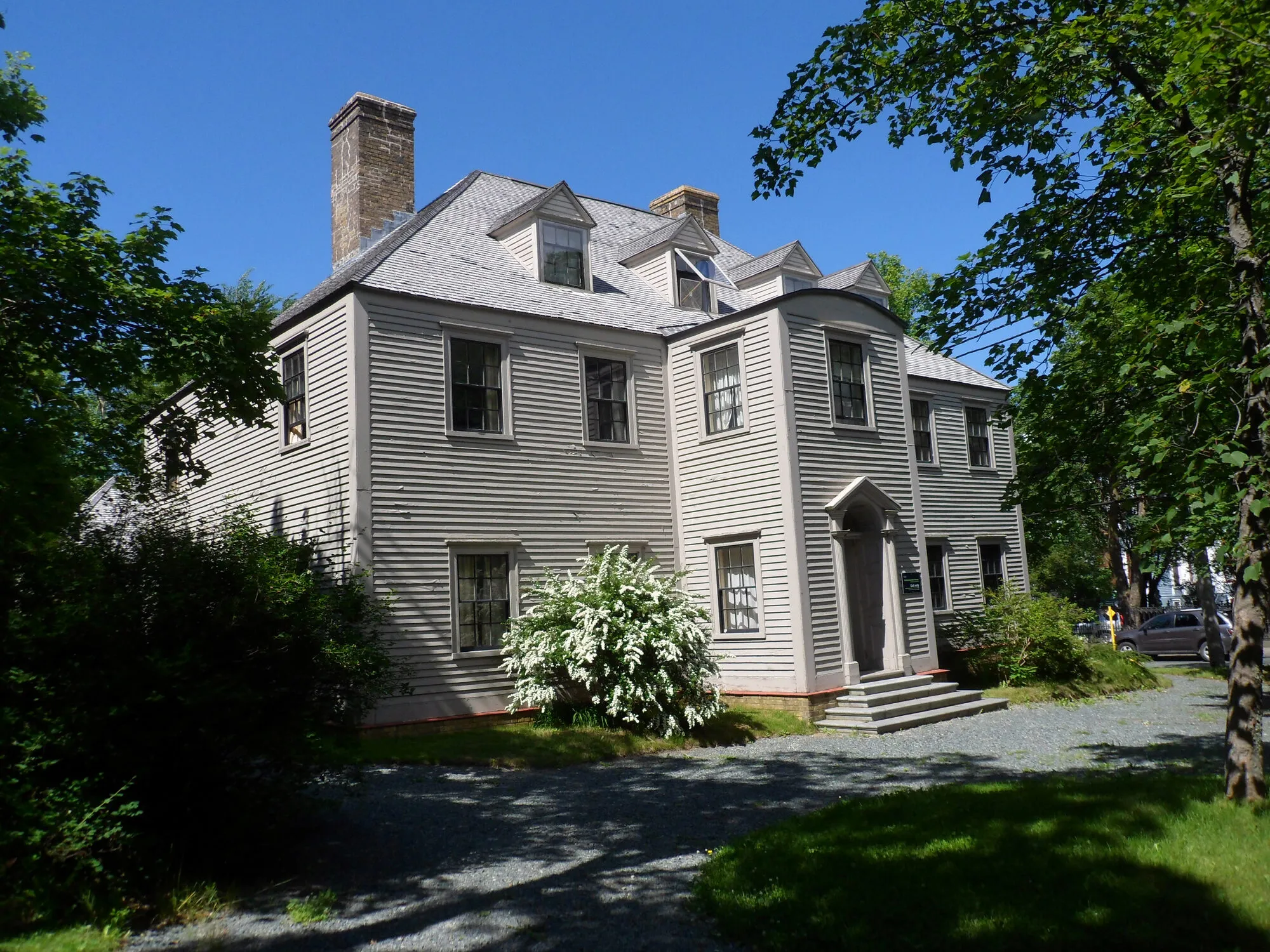 Commissariat House, a grey clapboard Georgian house with white trim, among trees in St. John's.