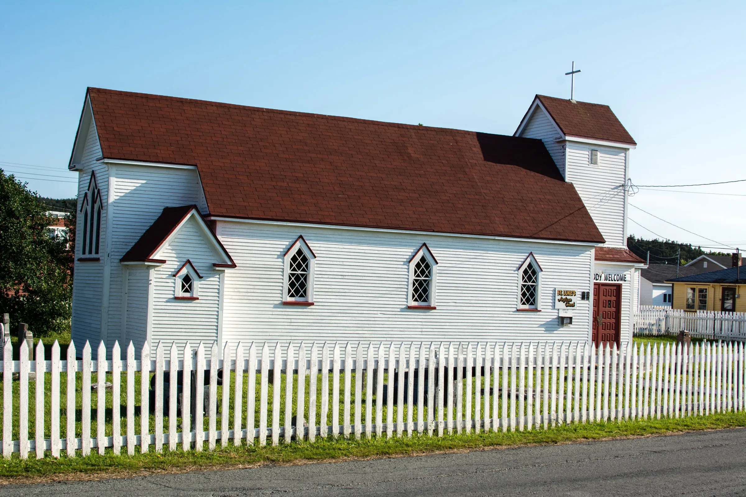 St. Luke's Anglican Church at Placentia, white clapboard with a steeple, above the town and the harbour.