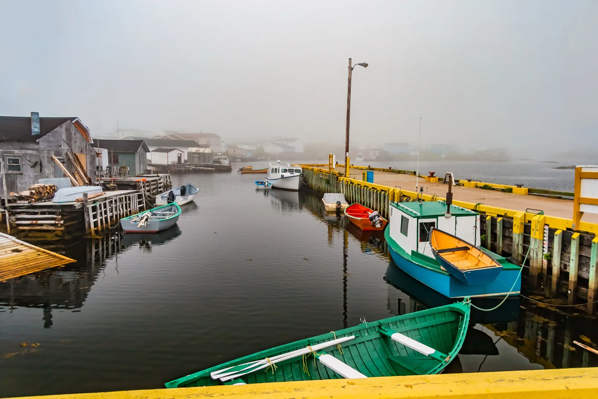 Colourful dories and wharf in Channel-Port aux Basques harbour.